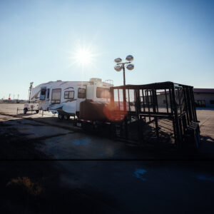 trailer with a light tower and trash trailer