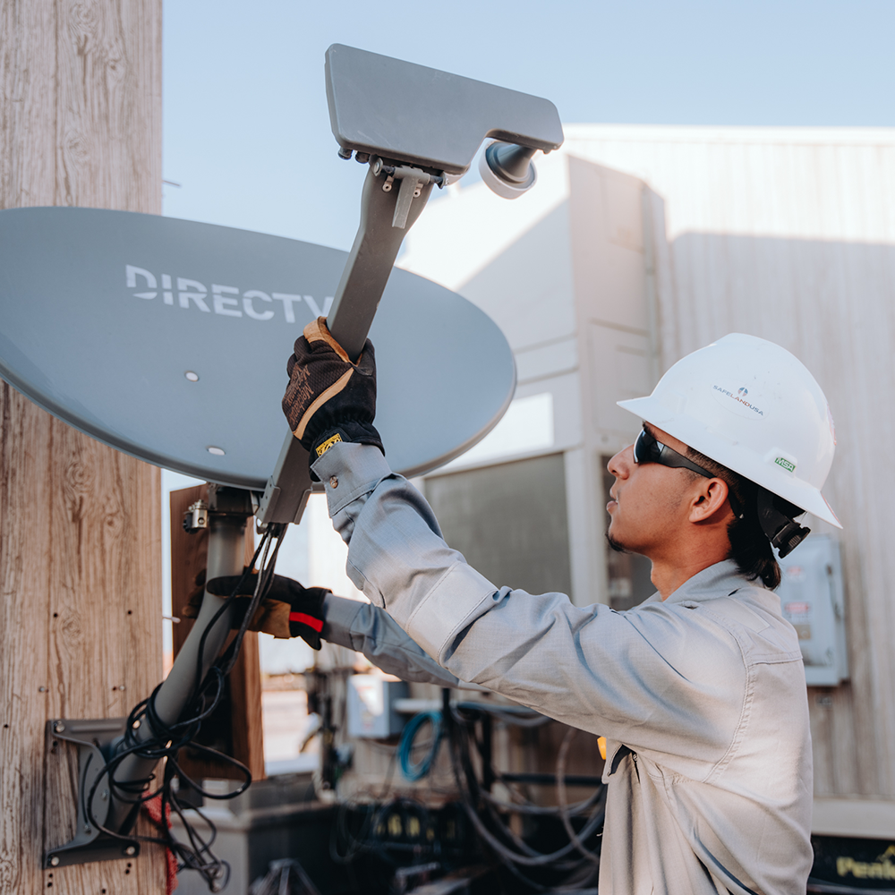 worker installing a satellite dish