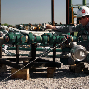 worker checking gauge on plug catcher