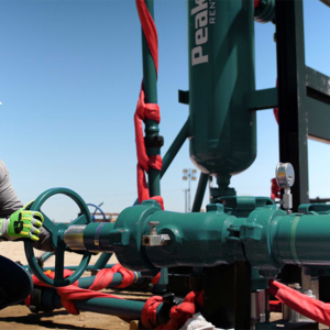 worker adjusting valve on a sand separator